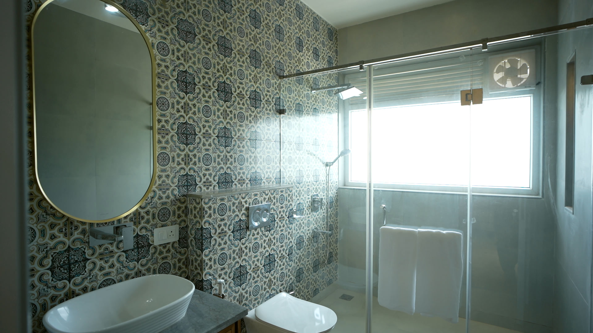 A bathroom in patterned blue cement tile