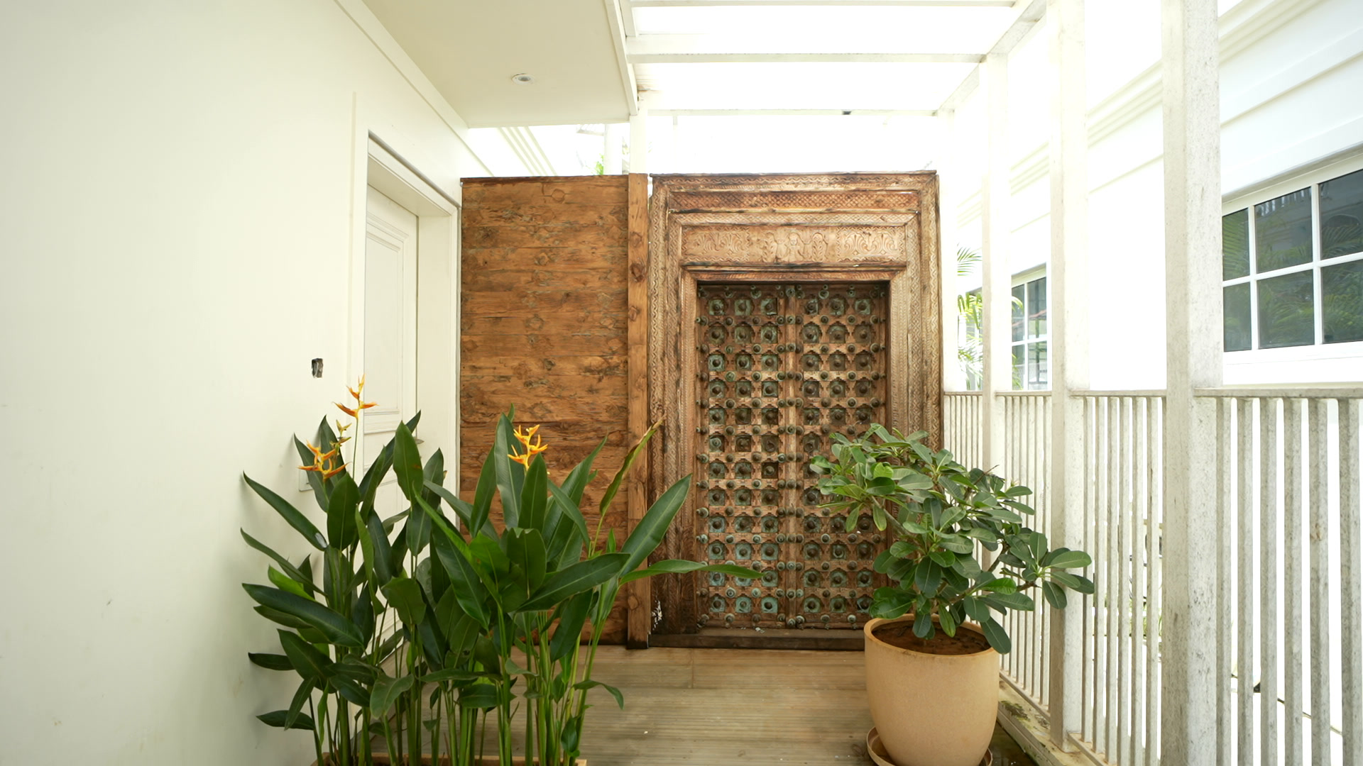 A carved antique timber door at the villa entrance