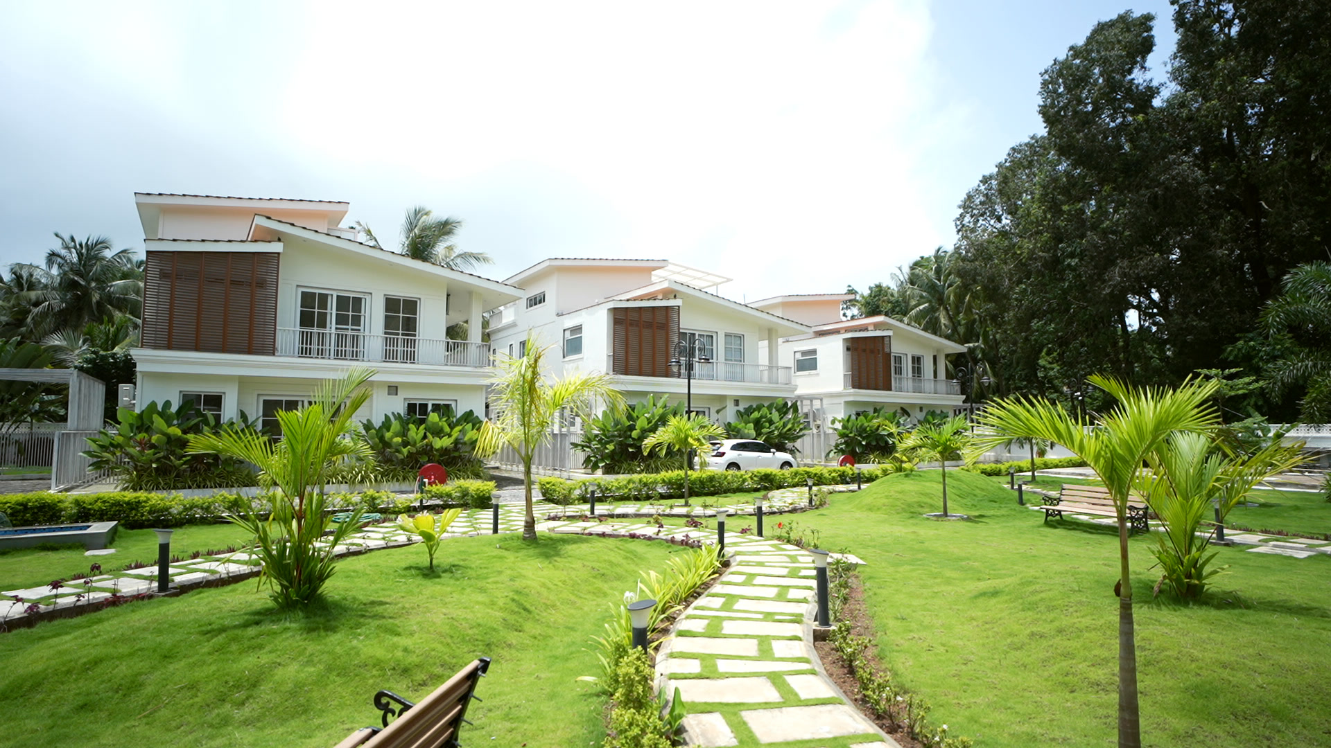 The community garden with stone paths and palms