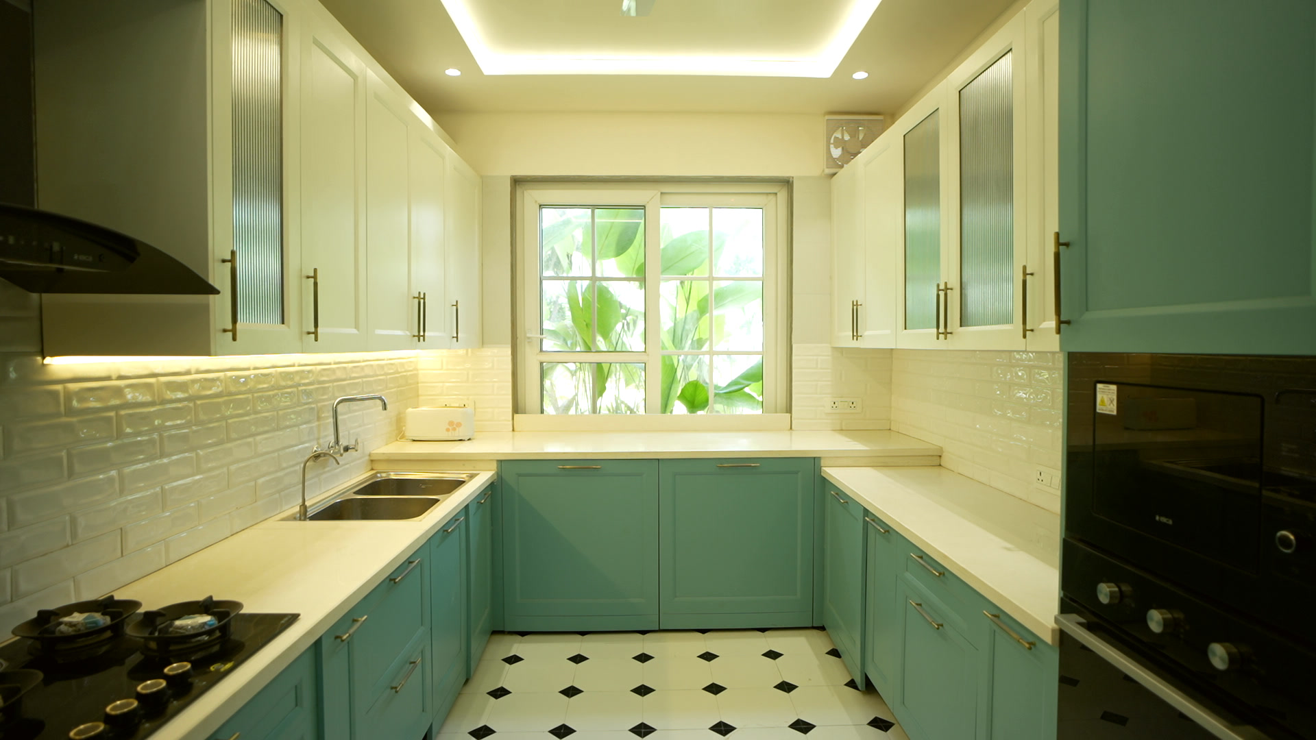 The mint-green galley kitchen