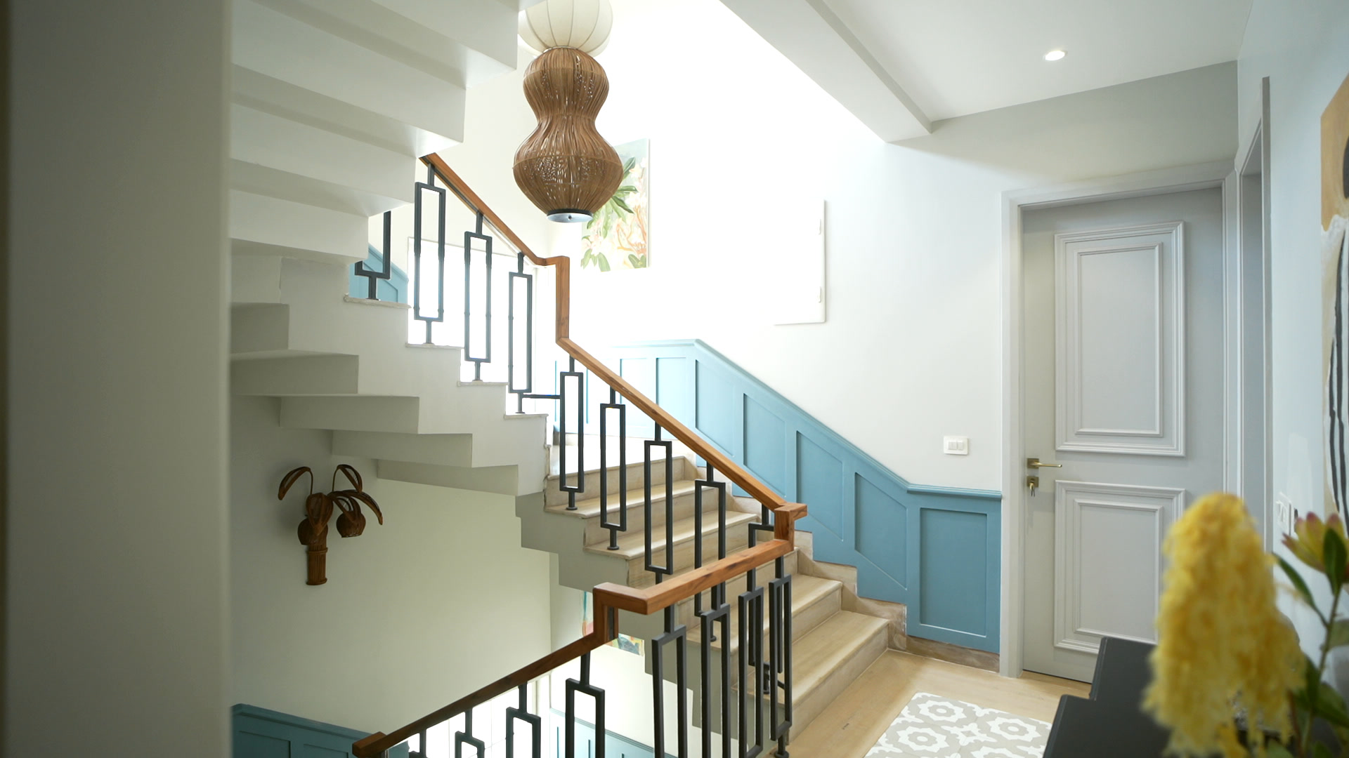 Timber and iron staircase under a woven pendant